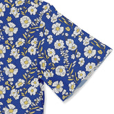 Shirt with delicate white flowers against a blue background, perfect for spring.