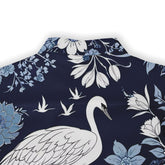 Elegant crane design on a shirt with detailed floral accents, inspired by nature.