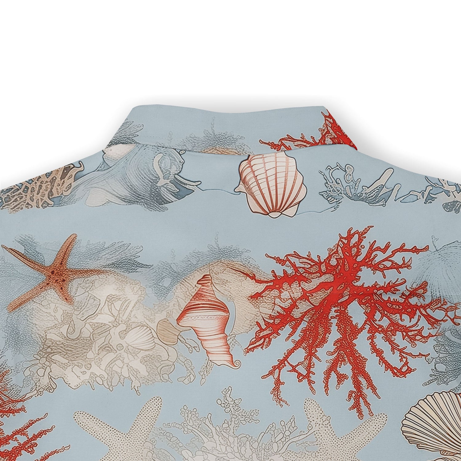 Blue shirt adorned with coral, starfish, and seashell motifs.