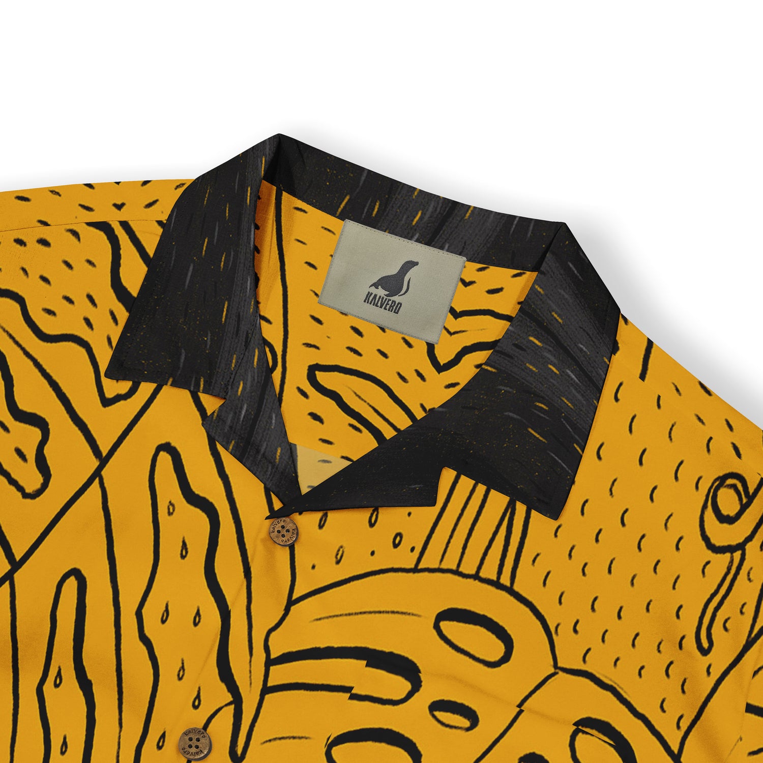 Close-up of a mustard yellow shirt collar with a black and abstract leaf pattern design.