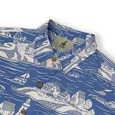 Seaside village pattern on a blue shirt, evoking coastal calm and adventure.