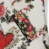 White shirt featuring a bold heart, roses, and swords design