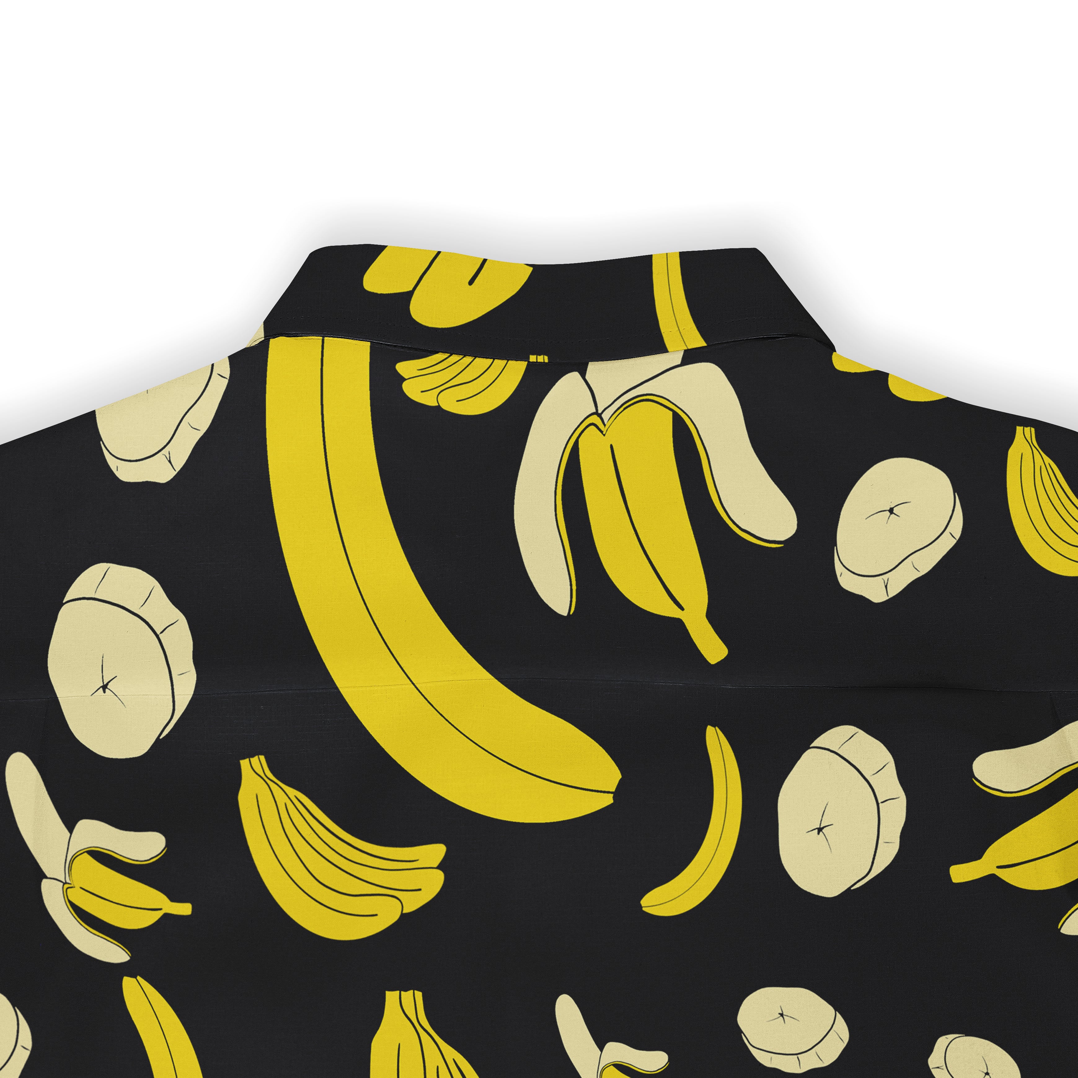 Back view of a black shirt featuring a playful banana print with vibrant yellow and cream whole bananas, peeled bananas, and banana slices, creating a fun and lively design.