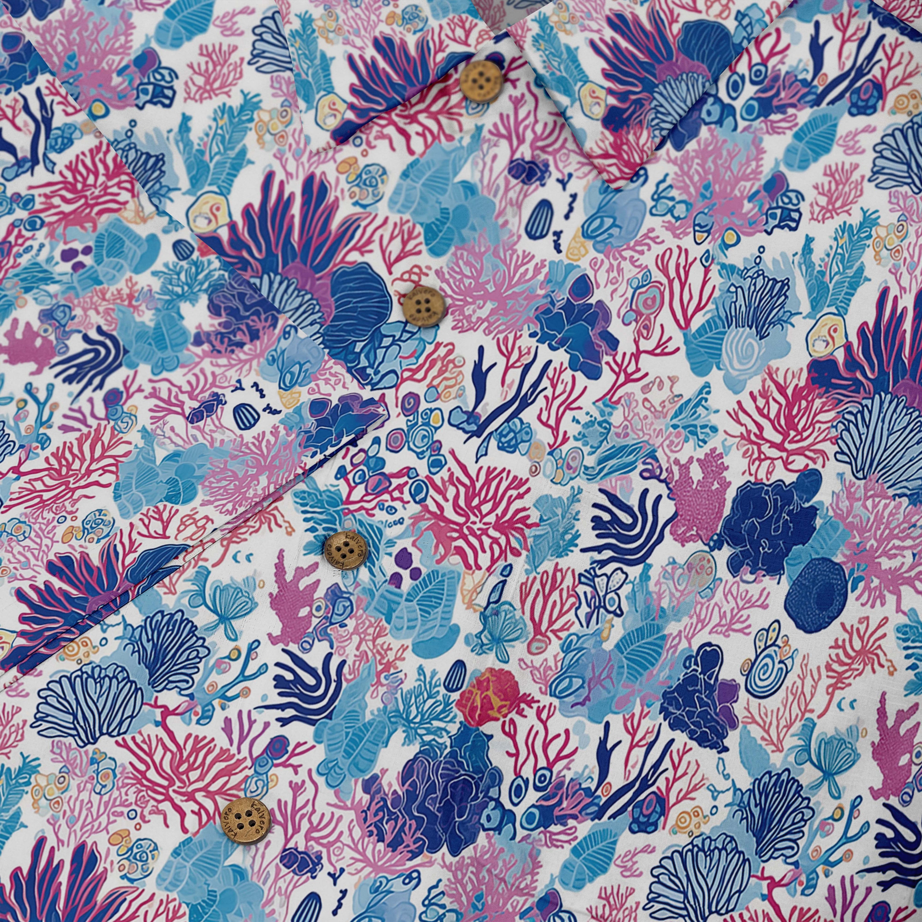 Colorful shirt featuring detailed coral reef and marine life designs in shades of blue, pink, and purple front buttons close-up