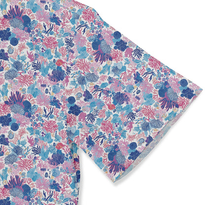 Colorful shirt featuring detailed coral reef and marine life designs in shades of blue, pink, and purple sleeve close-up