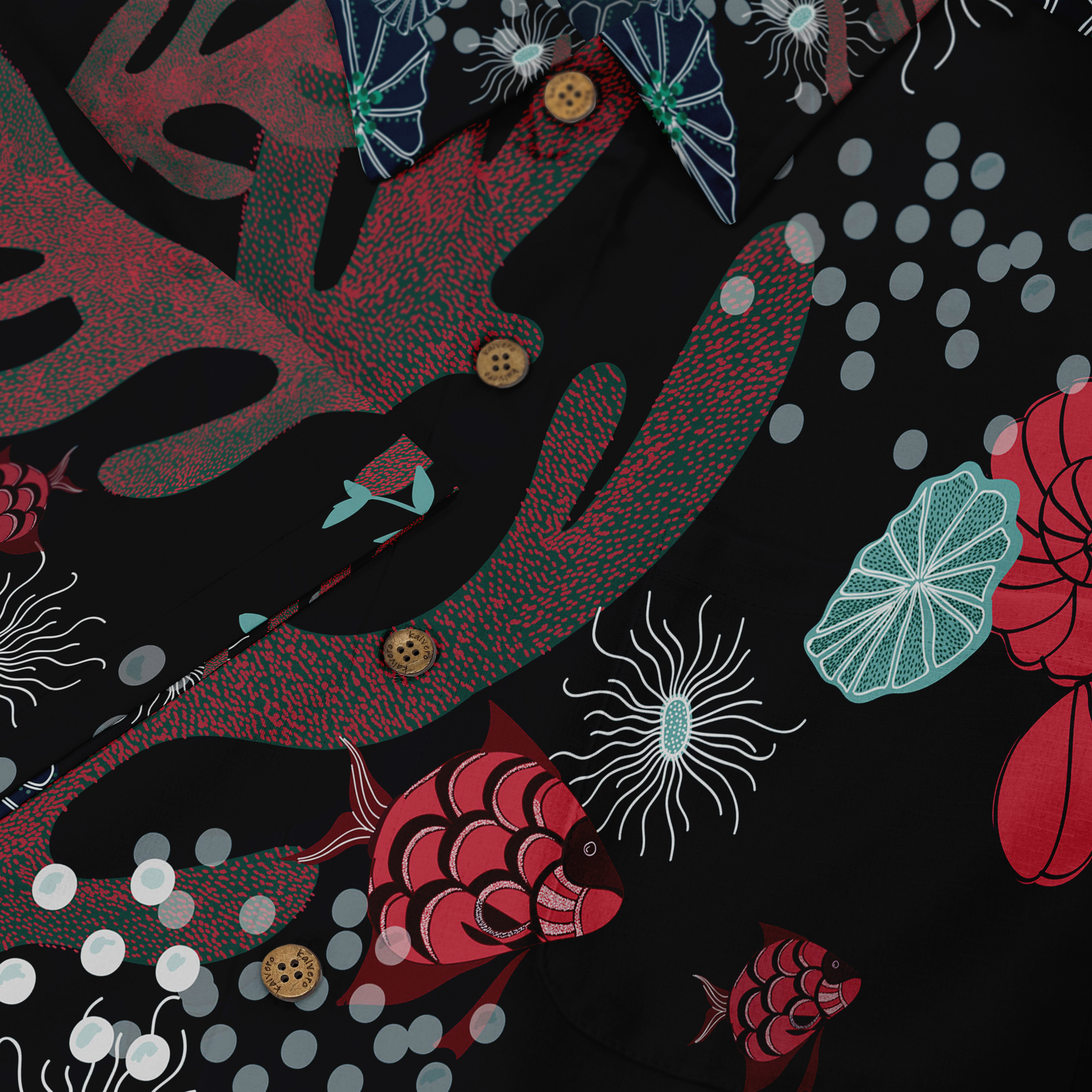 Close-up of a Hawaiian shirt featuring red fish, corals, and aquatic patterns on a dark background with button details.