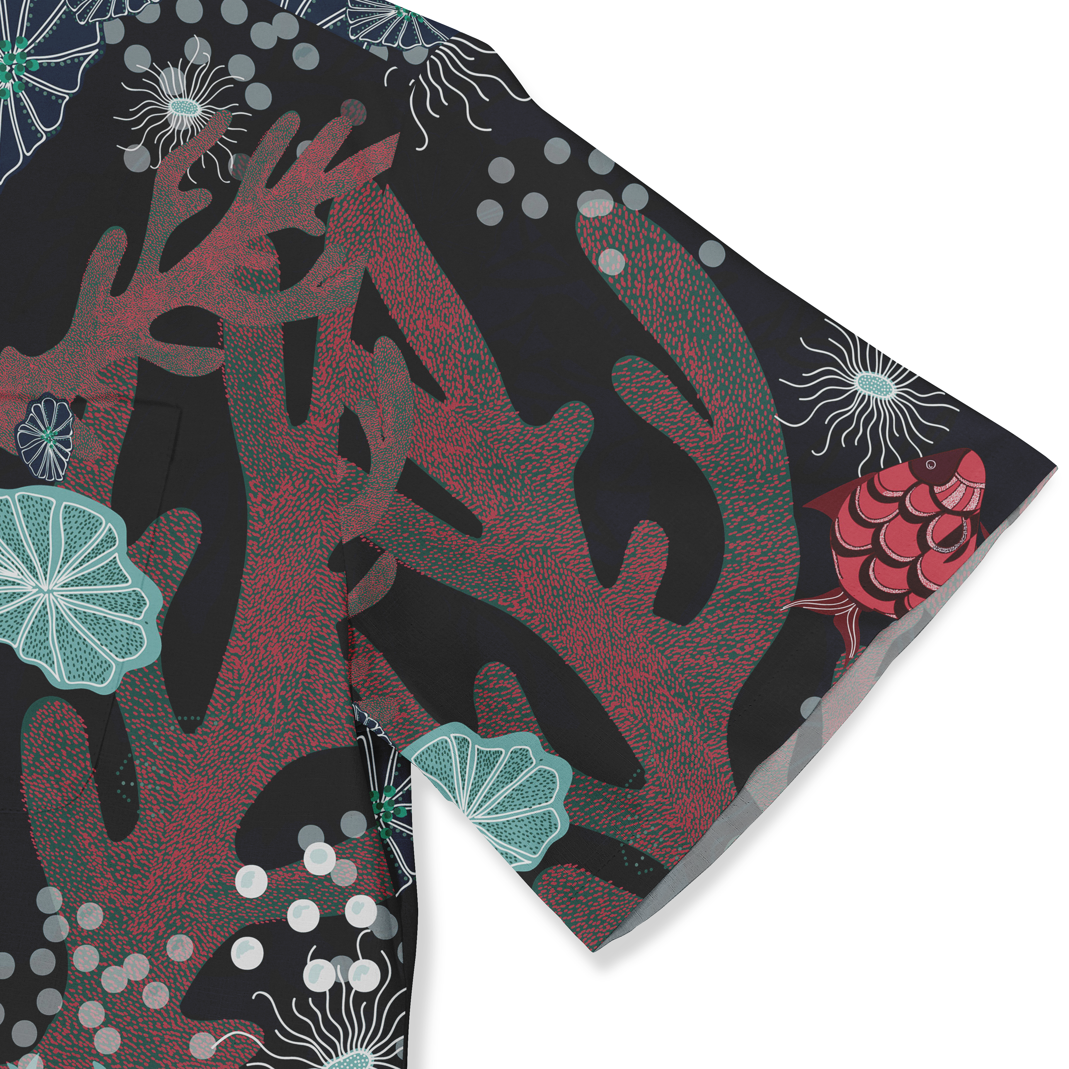 Close-up of a Hawaiian shirt sleeve showcasing a vibrant underwater-themed pattern with red corals, fish, and abstract sea elements on a dark background.