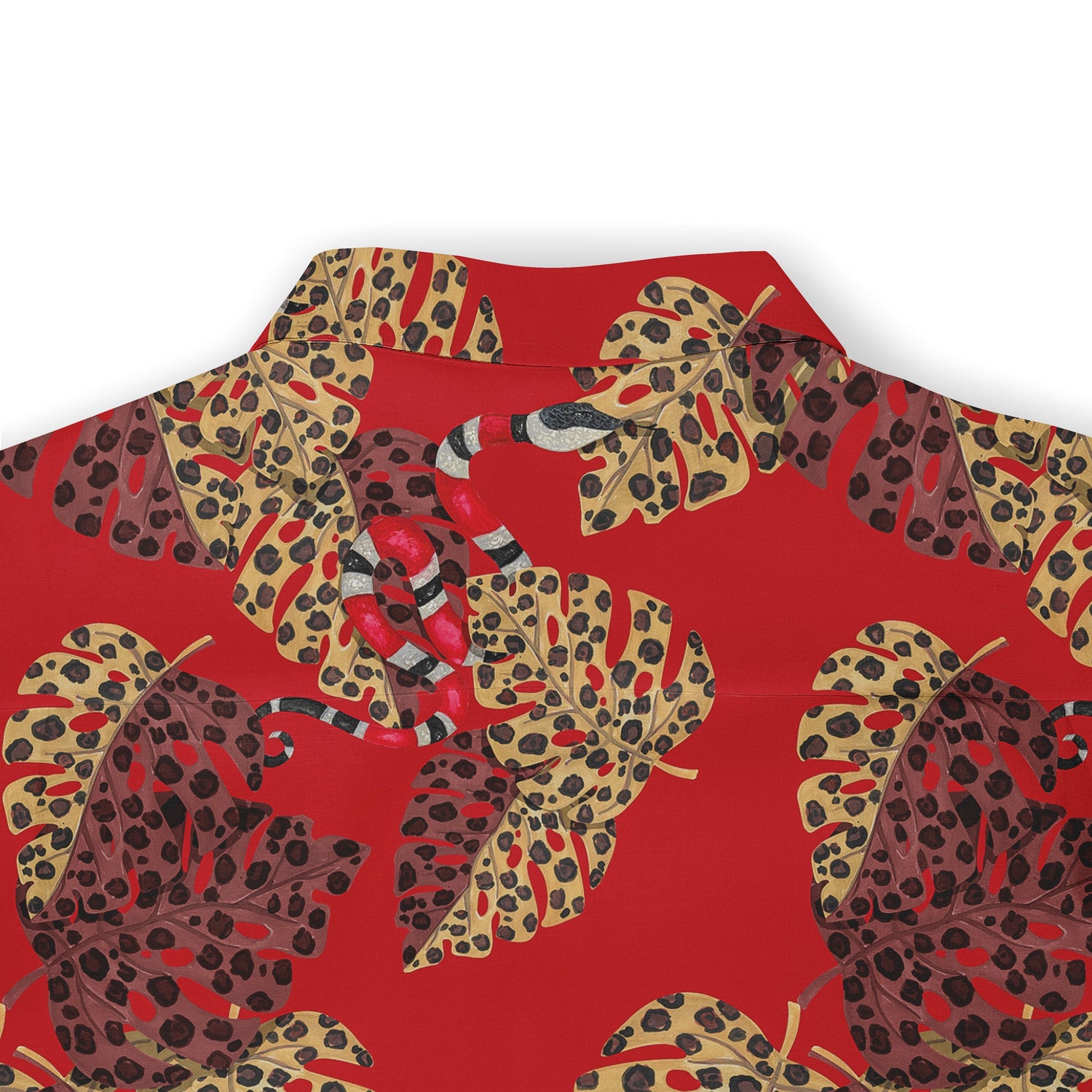 Close-up of the back of a Hawaiian shirt with a bold red background featuring large, leopard-print leaves in shades of yellow and brown, interspersed with a hidden snake motif.