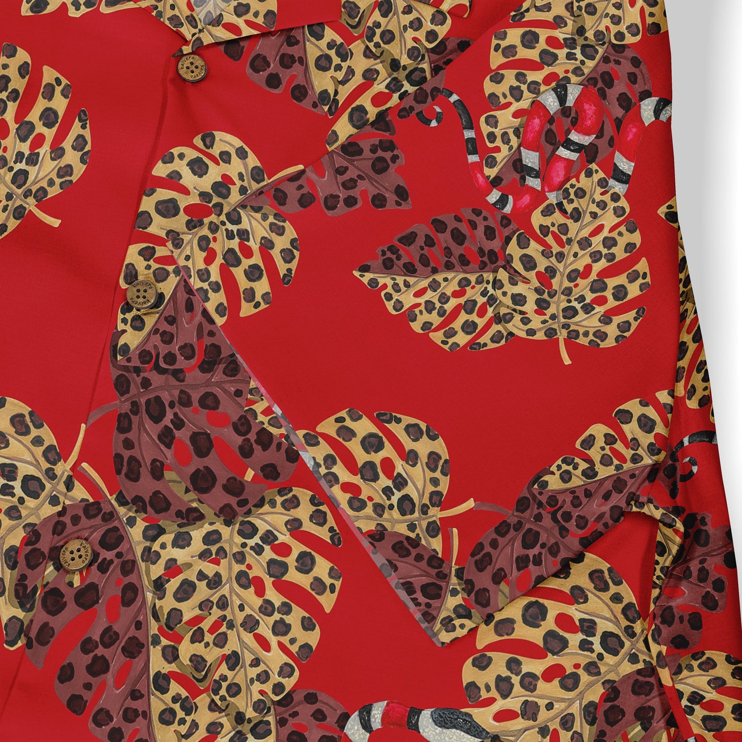 Close-up of a Hawaiian shirt showcasing a vibrant red fabric with large, detailed leopard-print leaves in shades of yellow, brown, and black, complemented by a hidden snake motif.