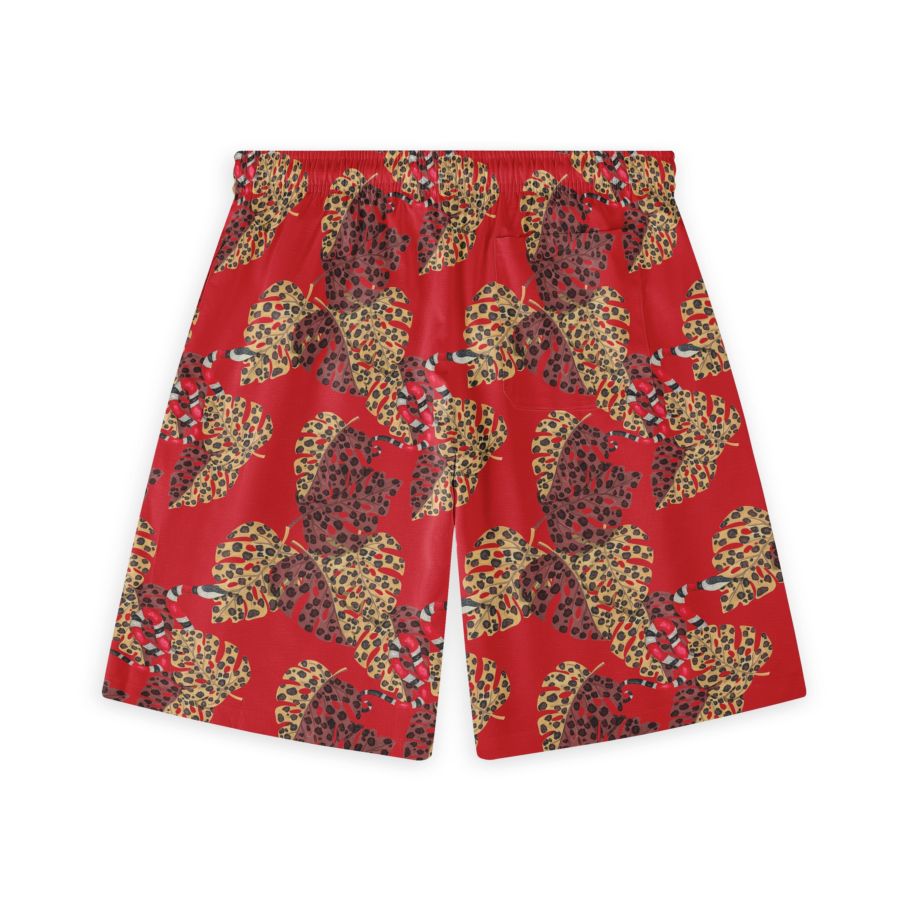 Hawaiian shorts with a red background, adorned with large, leopard-print leaves in yellow and brown tones, and subtle snake elements throughout the design.