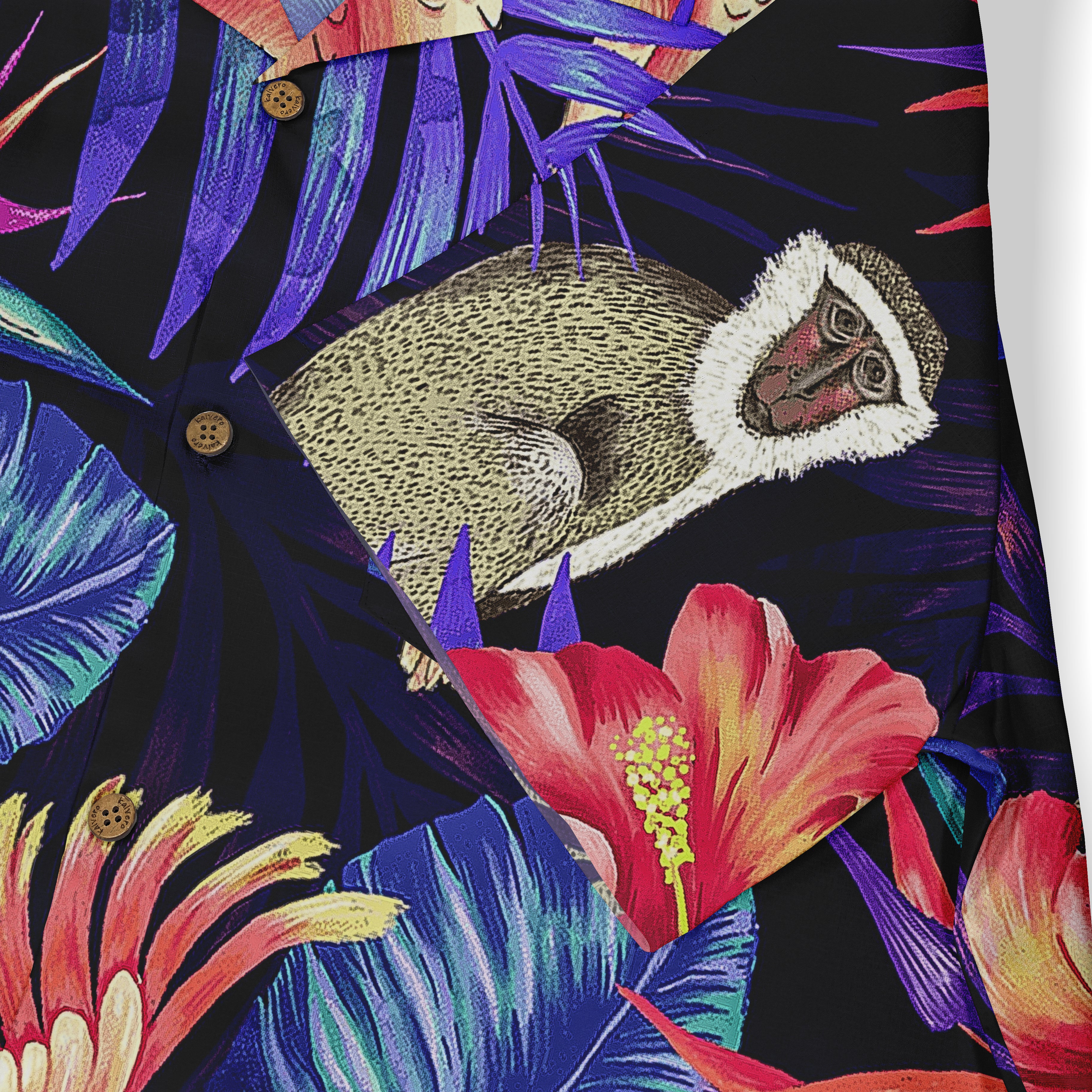 Close-up of a shirt featuring a vibrant tropical design with a monkey, large red flowers, and purple and blue leaves on a dark background.