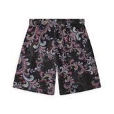 Back view of shorts with a paisley pattern featuring red, purple, and green swirls on a black background, showcasing the intricate design across the fabric.