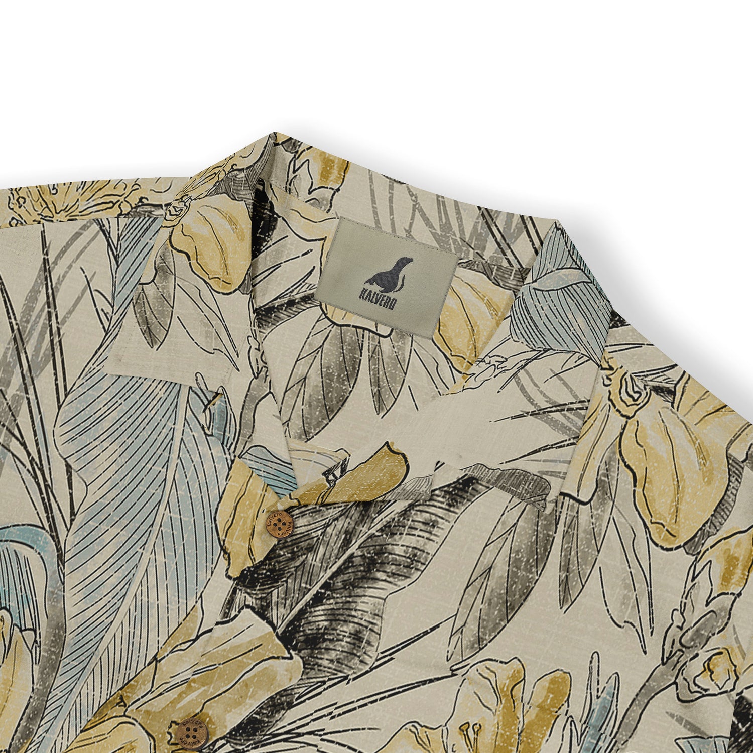 Close-up view of the collar of a Hawaiian shirt showcasing a detailed floral pattern in soft yellow, blue, and grey tones on a beige fabric, highlighting the Kalvero brand label.