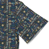 A short-sleeved shirt with an intricate geometric pattern in deep blues, greens, and golds. sleeve close-up