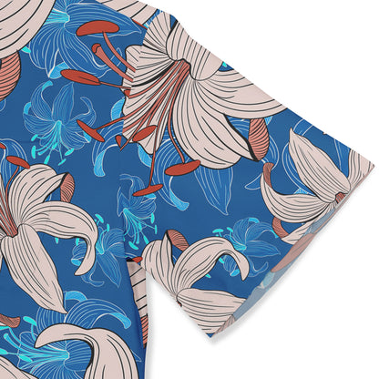 Close-up view of a Hawaiian shirt sleeve featuring a vibrant pattern of beige lilies with red-orange stamen and blue abstract floral designs on a bright blue background.