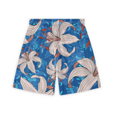 Back view of shorts featuring a vibrant design with large beige lilies and orange accents against a bright blue background.