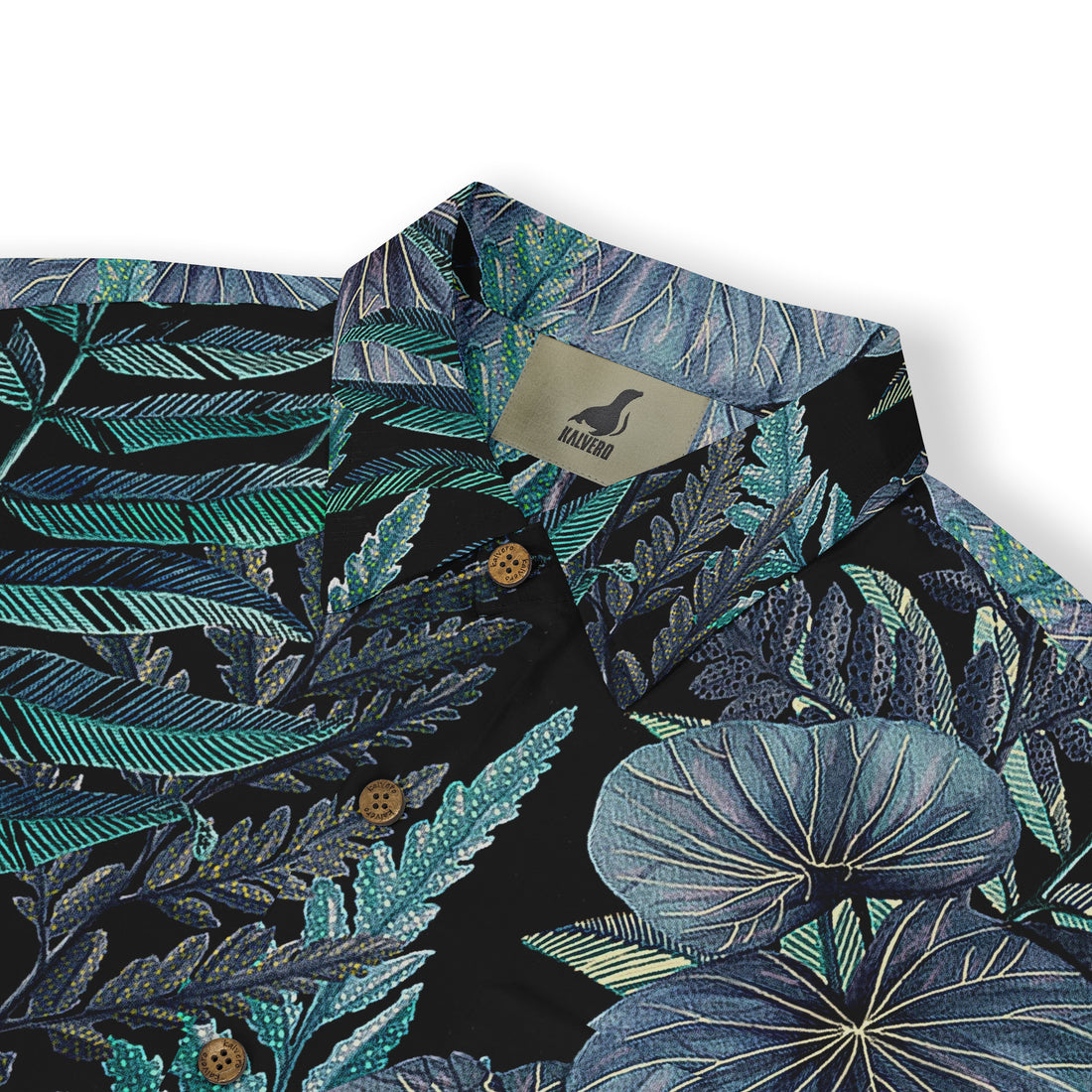 A close-up of a Hawaiian shirt collar featuring intricate tropical leaf patterns in various shades of blue and green, highlighting the vibrant and detailed design on a dark background. The shirt has a &quot;Kalvero&quot; label on the inside.