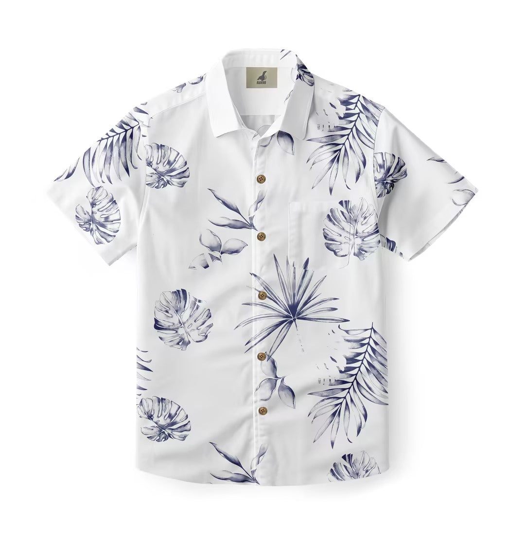 A shirt with a serene botanical pattern featuring various tropical leaves in soft blue tones on a white background.