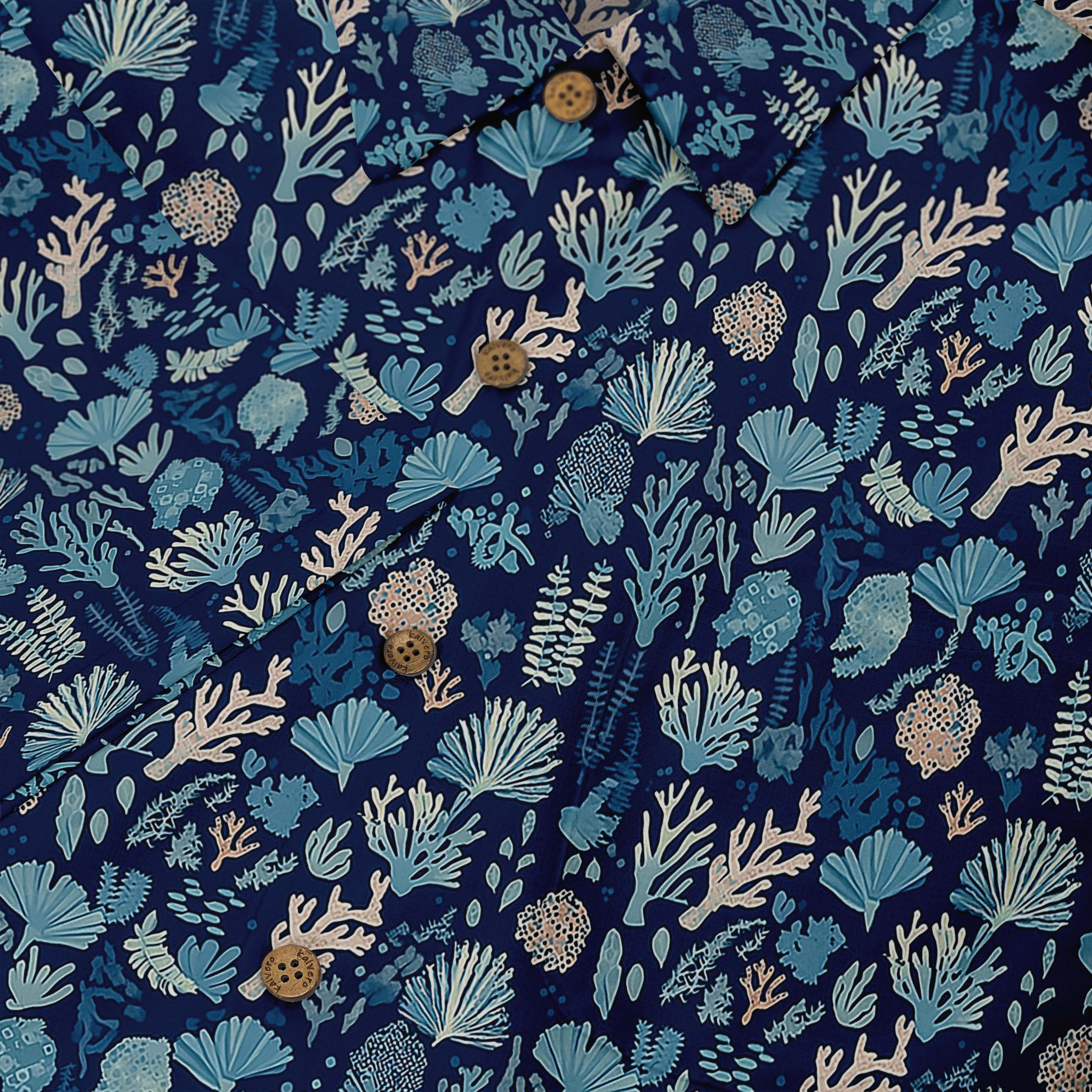 Deep blue shirt with delicate coral and seaweed illustrations depicting a nighttime ocean scene front buttons close-up