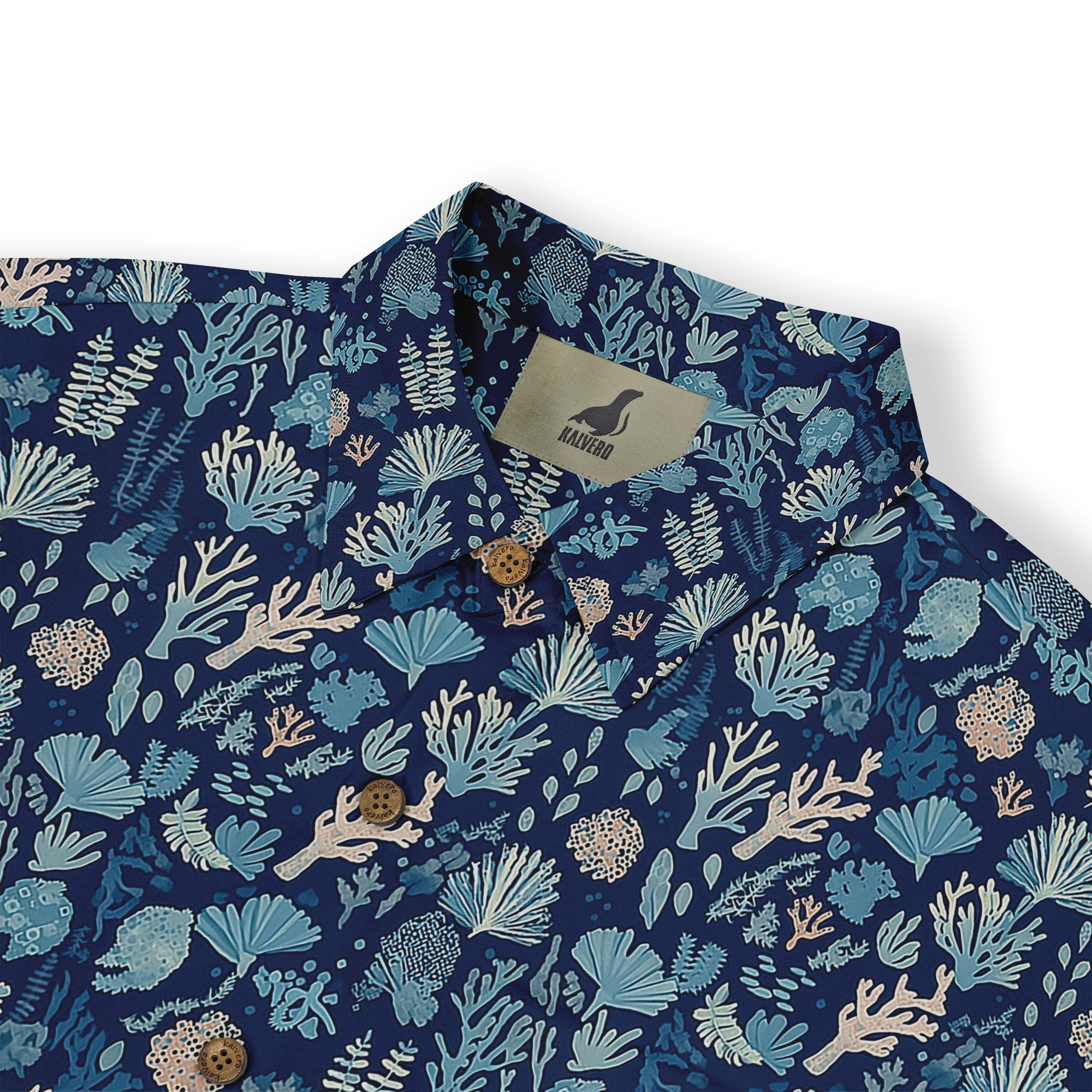 Deep blue shirt with delicate coral and seaweed illustrations depicting a nighttime ocean scene front view