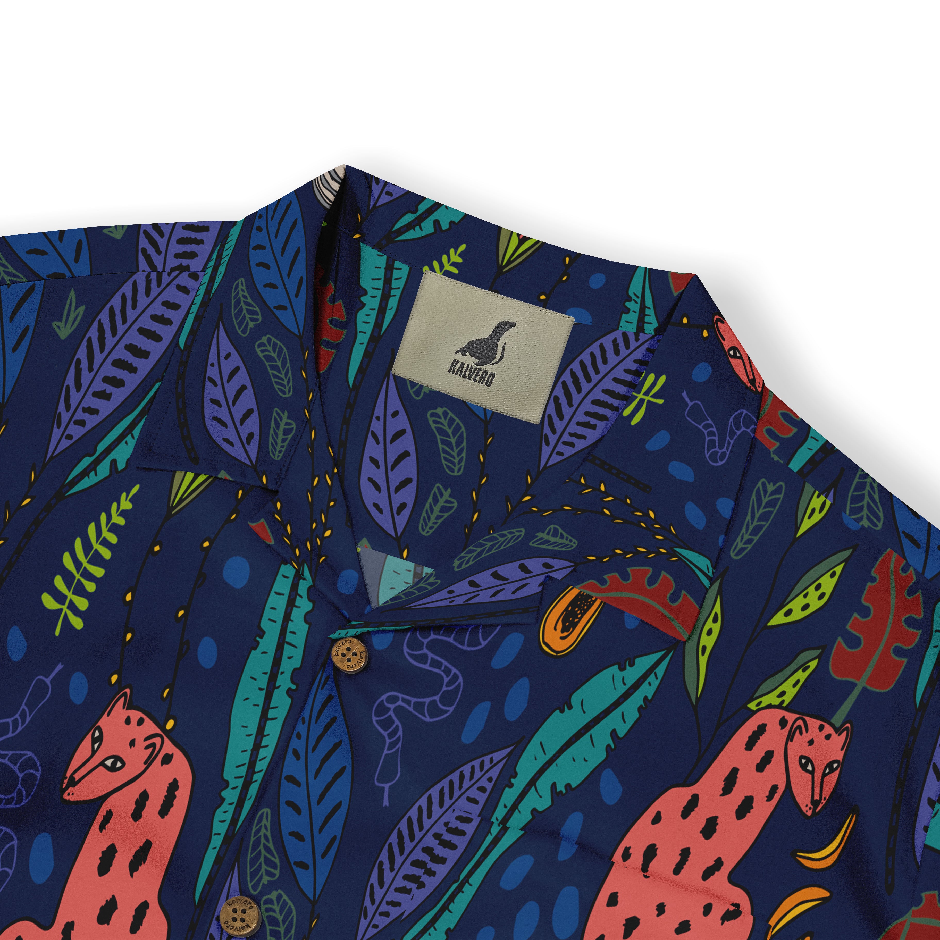 Close-up of a shirt collar featuring a deep blue background with a lively pattern of pink leopards, various colorful leaves, and abstract shapes.