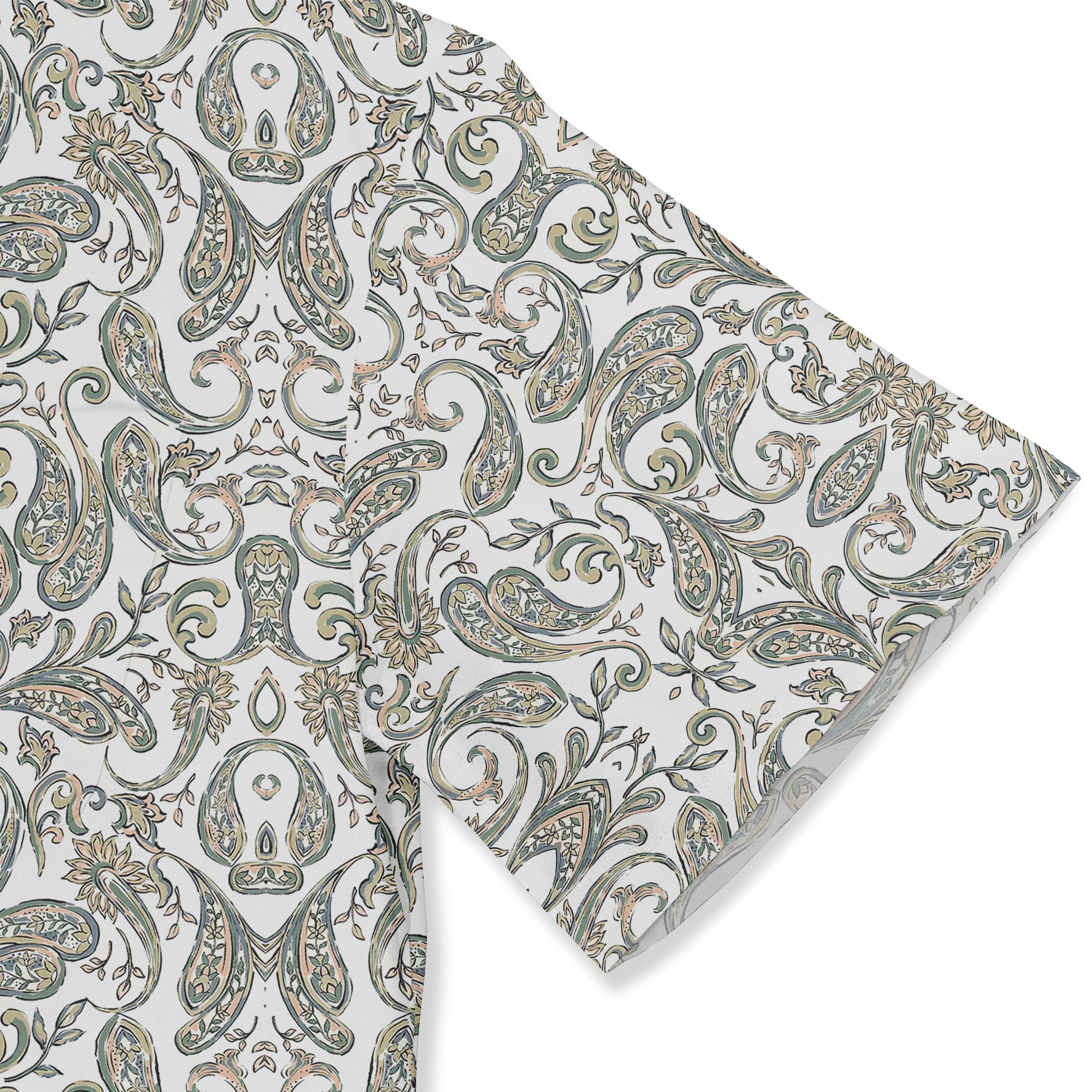 A short-sleeved shirt with a &quot;Serenity Scrolls&quot; pattern, featuring blue and white paisley motifs and floral vines framed by geometric borders sleeve close-up