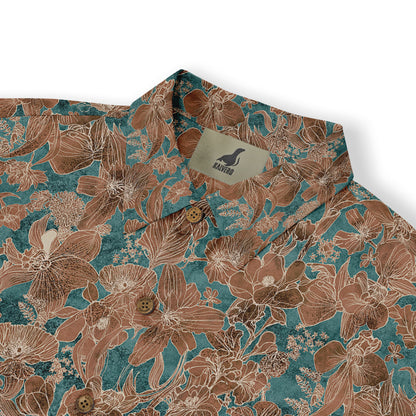 Close-up of a Hawaiian shirt collar with a detailed floral pattern in brown and teal tones, featuring brown buttons.