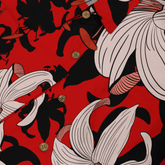 Bold lilies on vibrant red with striking black accents.