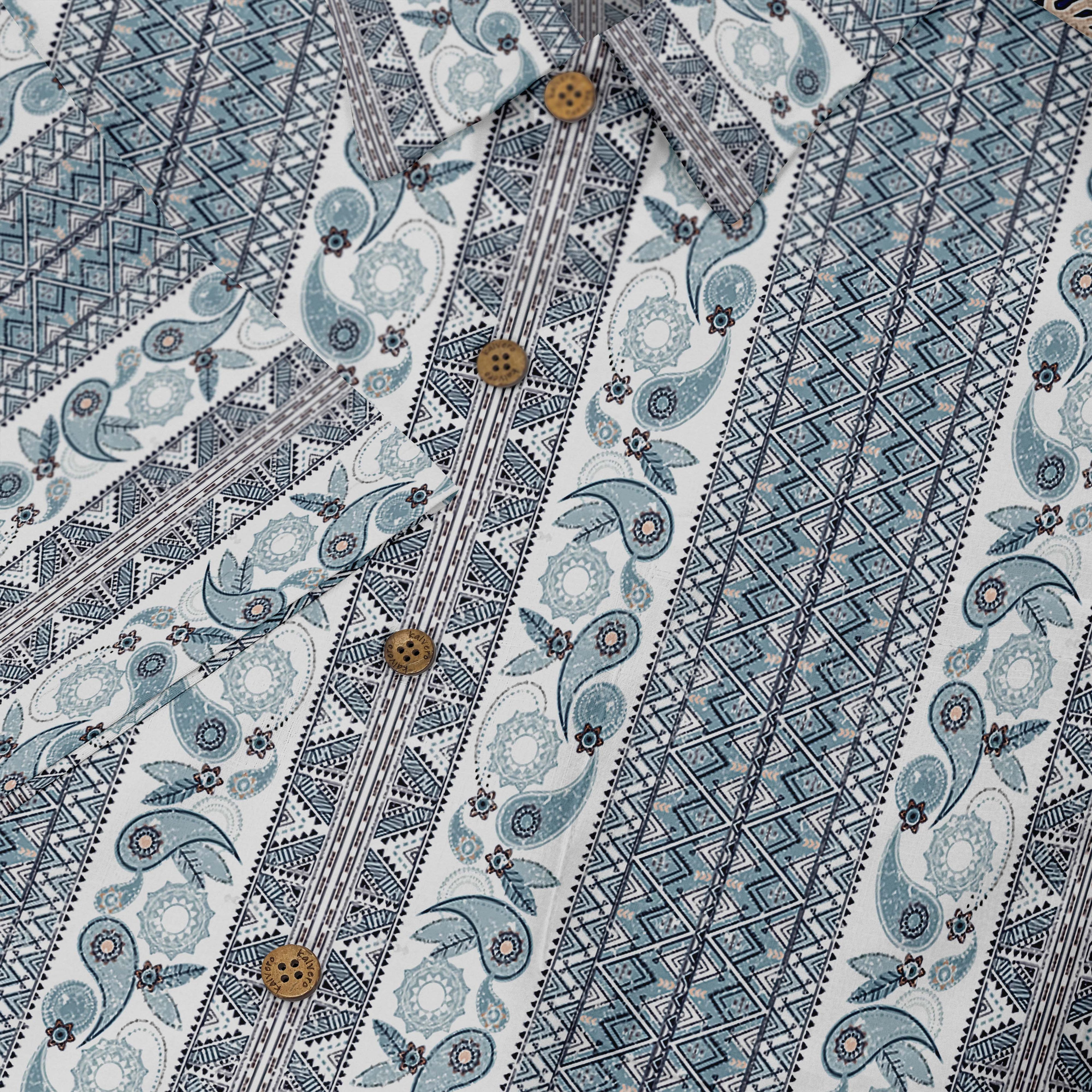 A short-sleeved shirt with a &quot;Serenity Scrolls&quot; pattern, featuring blue and white paisley motifs and floral vines framed by geometric borders front buttons close-up