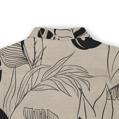 Close-up view of the back collar of a shirt, showcasing a beige fabric with black leaf outlines, capturing a minimalist, nature-inspired design.