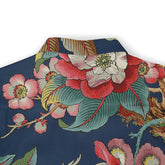 Close-up of a shirt collar with a vibrant floral design featuring red, pink, and white flowers and green leaves on a dark blue background.