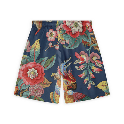 Shorts with a vibrant design featuring a colorful parrot among large tropical flowers and foliage on a deep blue background.