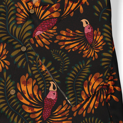 Close-up of a shirt featuring a tropical design with green leaves and orange parrot motifs on a dark background. The fabric is detailed with button accents.