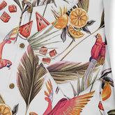 This close-up emphasizes the vibrant tropical pattern with elements like parrots, oranges, and leaves, making it a lively and summery design.