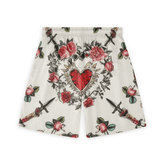 This is the back view of a pair of shorts featuring a bold design with a central heart motif surrounded by roses and swords, set against a light background. The pattern combines elements of romance and edginess, creating a striking and dramatic look.