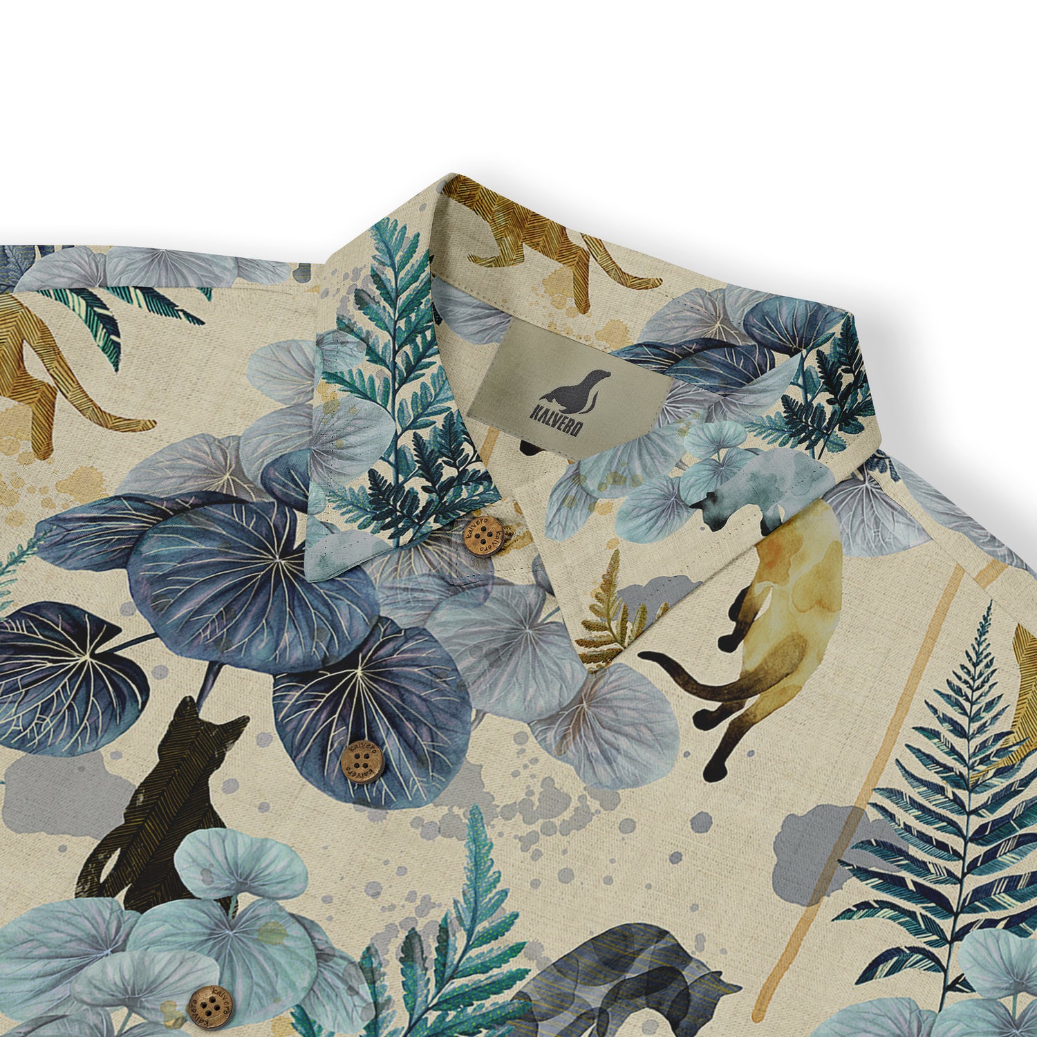 This is a close-up of a shirt featuring a design with botanical elements and leopard motifs in shades of blue, green, and beige, set against a textured, earthy background. The details include plant leaves, leopard silhouettes, and textured buttons, creating a blend of nature and wildness.